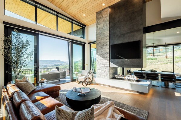 Cozy space with a Smart TV, warm gas fireplace and lake views