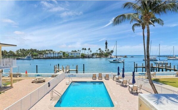 Heated pool with view of the lighthouse and inlet.