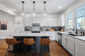 Spacious kitchen featuring a large island with seating, perfect for casual meals and gathering while cooking.