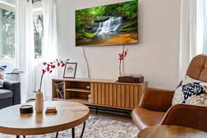 Chill in our stylish living room featuring a flat-screen TV, perfect for unwinding after exploring the area.