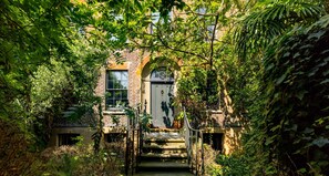 Malplaquet House charming brick facade surrounded by lush greenery