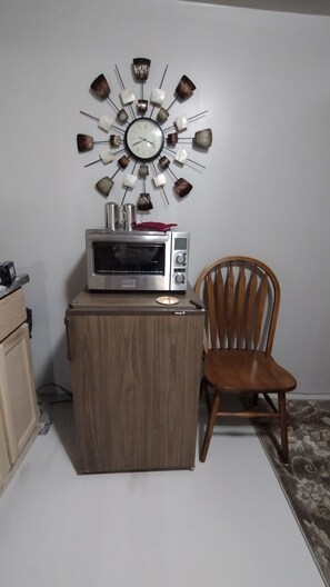 Mini Fridge and oven, stove, and coffee maker.