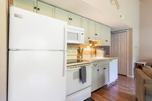 The open, airy kitchen offers ample storage & every home comfort