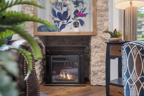 Cozy and spacious living area with TV and fireplace