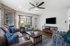 Cozy and spacious living area with TV and fireplace