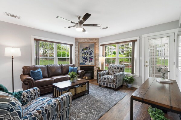 Cozy and spacious living area with TV and fireplace