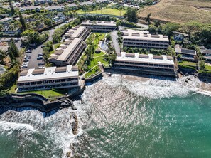 Aerial view of oceanfront Kahana Sunset Resort in Maui paradise.