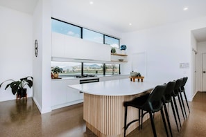 Turn up the heat on the gas stove and serve up some pancakes and breakfast in the kitchen with bar seating. 
