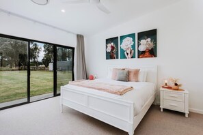 The primary bedroom is the perfect escape with a king-sized bed, direct lawn access, a private ensuite and walk-in robe. 