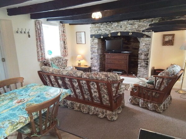 Lounge area with sofa, armchair, fireplace