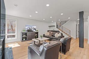Enjoy modern decor, a warm gas fireplace, and a big-screen TV in this spacious living room designed for comfort