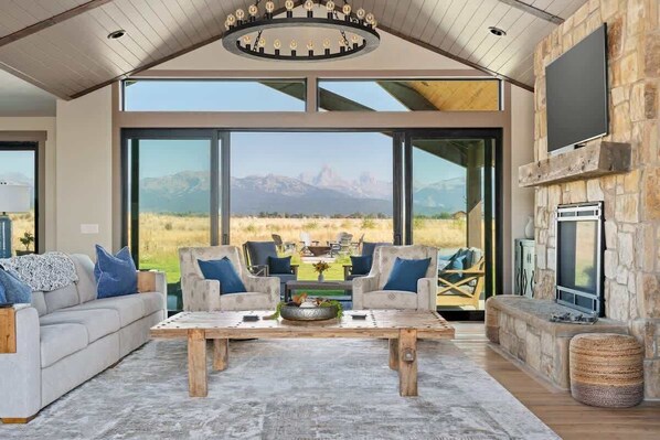 The large windows and sliders blend the outdoors and indoors to create a stunning living room.