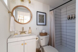Spacious bathroom (for a tiny home!) with a hair dryer & steamer available to help you get ready for a night on the town