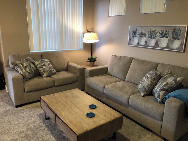 Cozy and relaxing living room space featuring comfortable sofa and loveseat