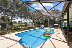 Swim in your private pool with a screen-enclosed shed and stunning canal views for the ultimate retreat!