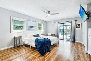 Cozy and stylish second bedroom featuring a Smart TV