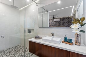 Unwind in the modern bathroom equipped with a rain shower—perfect for a refreshing start or end to your day.