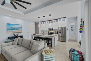 The open floor plan of the living room and kitchen is spacious and perfect for entertaining.