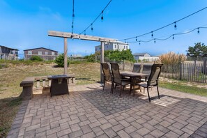 Gather around the gas fire pit under the warm glow of Edison lighting for cozy evenings and storytelling.