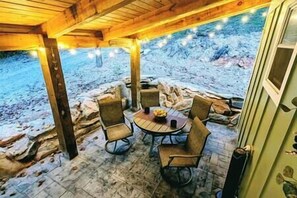 Outdoor dining surrounded by unique, beautiful natural rock walls. 