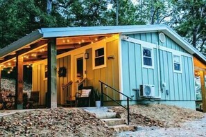 Charming front porch with party lights and outdoor dining area.