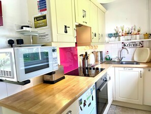 SaltWater kitchen. Microwave, full size oven and halogen hob, kettle, toaster. Equipped with the usual cutlery and crockery enough for 4 people