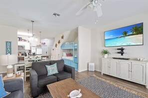 Bright and inviting living room with cozy seating and ample natural light—perfect for relaxation or entertaining