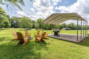 Peaceful backyard space, with a grill and a picnic table not pictured.