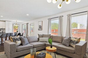 Modern, posh, and welcoming, this living room offers the perfect blend of classic charm and modern comforts that beckon you to come in and stay a while. 