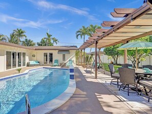 Backyard comes equipped with plenty of seating and of course a heated pool!