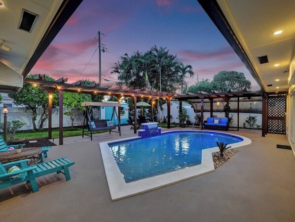 Backyard comes equipped with plenty of seating and of course a heated pool!