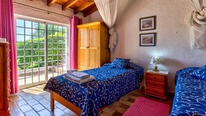 Cozy twin bedroom with terrace access, offering tranquil garden views.
#AlgarveRetreat #PrivatePoolVilla #MountainViews #FamilyGetaway #RusticCharm #RelaxInTheSun #AlgarveVacation
