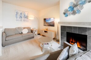 Living Room with double size sofa bed, Smart TV and fireplace