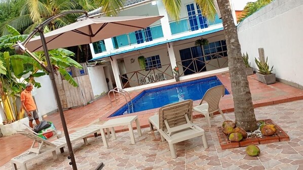 Front of Home with freshwater pool and lounging area