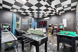 This game room is an arcade lover’s dream! With multiple arcade games, foosball, pool table, air hockey, ski ball, and cozy seating, there's endless fun for everyone.