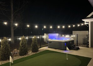 Unwind in the hot tub overlooking the putting green, pool and golf course.
