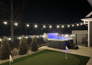 Unwind in the hot tub overlooking the putting green, pool and golf course.