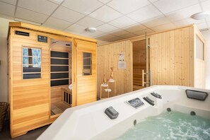 Unwind in the shared wellness area with a hot tub and sauna. Includes one free spa session, with additional access available for a fee.