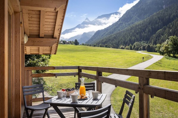 Enjoy your meals alfresco on this balcony with breathtaking views of the valley and surrounding mountains. The perfect spot for morning coffee or sunset dinners while soaking in the fresh alpine air.