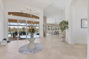 Foyer going into dining room and living room area with fantastic view of private pool and canal beyond