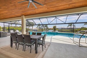 Huge, beautiful lanai with canal view. Lanai features pool, dining table seating 8,  6 sun Loungers, patio conversation furniture, and 55-inch Smart TV