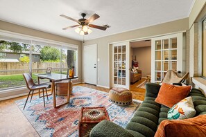 Office with couch, dedicated workspace, and ceiling fan"