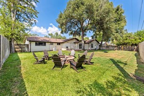 Backyard patio with outdoor seating around firepit