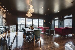 McBee House: Experience the magic of this bright living and dining space, where stunning windows welcome warmth and foster a welcoming atmosphere.
