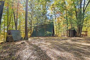 Escape to this charming A-frame cabin nestled deep in the forest. Surrounded by towering trees and vibrant nature, this secluded getaway offers a peaceful retreat. 