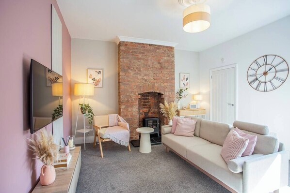 This living room features a bright and airy atmosphere, with its crisp white walls and matching white sofas that create a clean and elegant look.