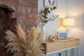 The arrangement of pampas grass in the foreground adds a natural, bohemian touch, creating a warm and inviting atmosphere. 