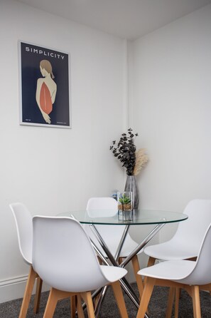 Gather around in this stylish mini dining area, perfect for intimate meals or enjoying your morning coffee.