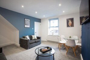 Whether you're here for work or leisure, this living area offers a perfect combination of comfort and style, providing everything you need to feel at home.