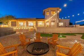 Imagine this: As twilight sets in, your backyard becomes a magical retreat. The warm glow of string lights, the crackling fire pit, and a fun mini-golf course create the perfect ambiance for relaxation and entertainment. Pure bliss!